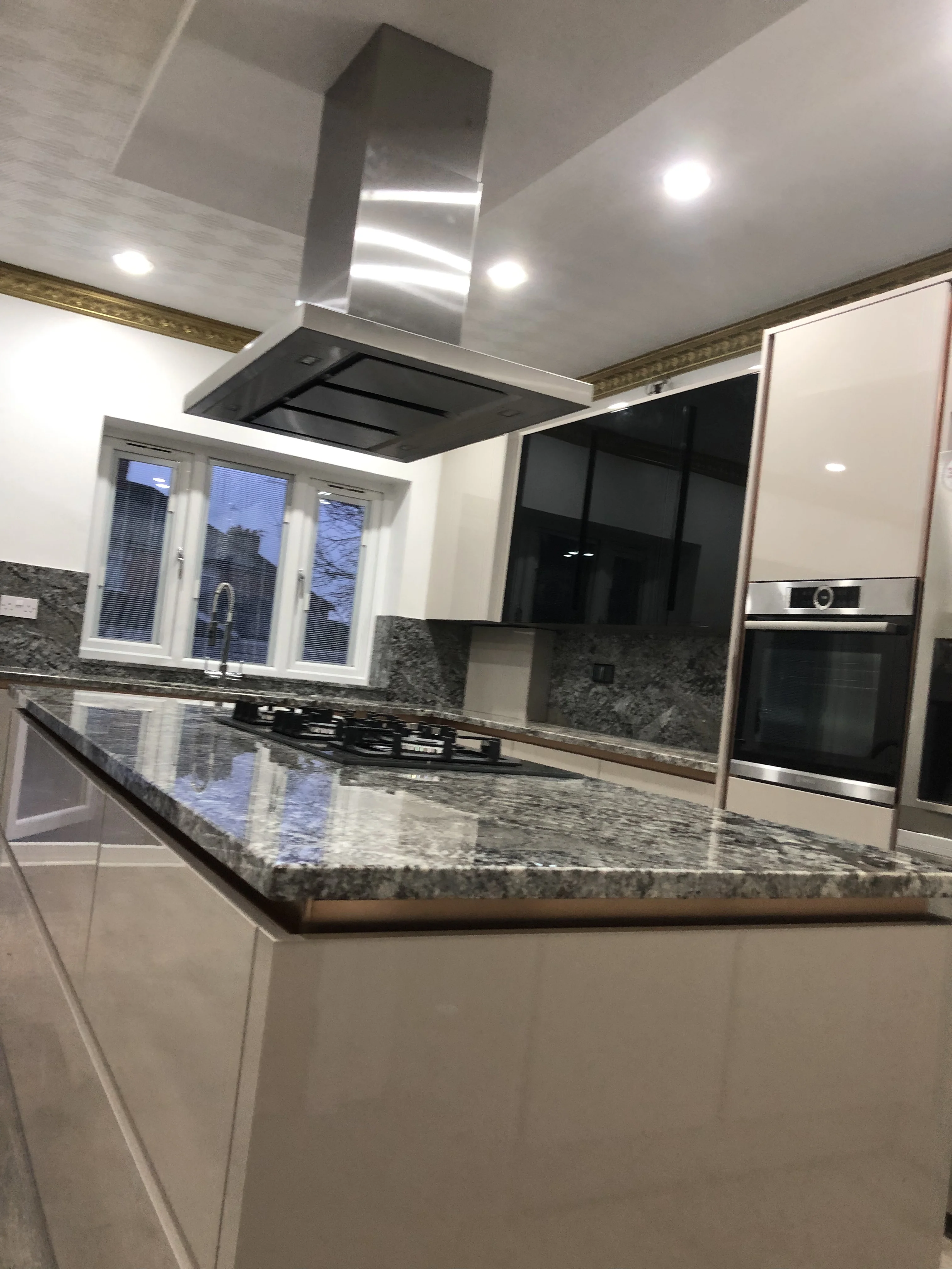 Kitchen fitter Nuneaton — white gloss kitchen with granite island fitted in Nuneaton, Warwickshire
