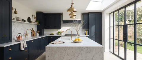 Luxury kitchen with marble island and brass pendant lighting